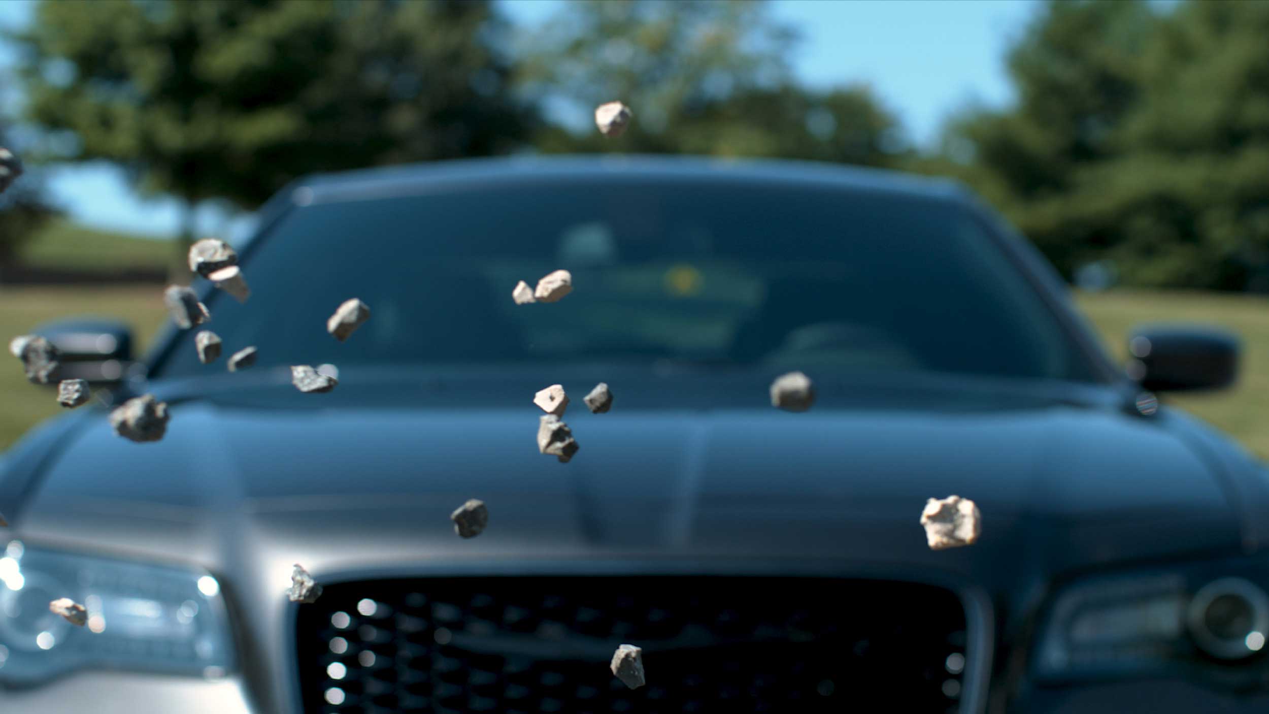 Rocks flying towards a car windshield